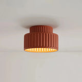 Cream flush ceiling light mounted close to the ceiling