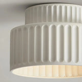 Close-up of the ribbed resin shade on a cream flush ceiling light