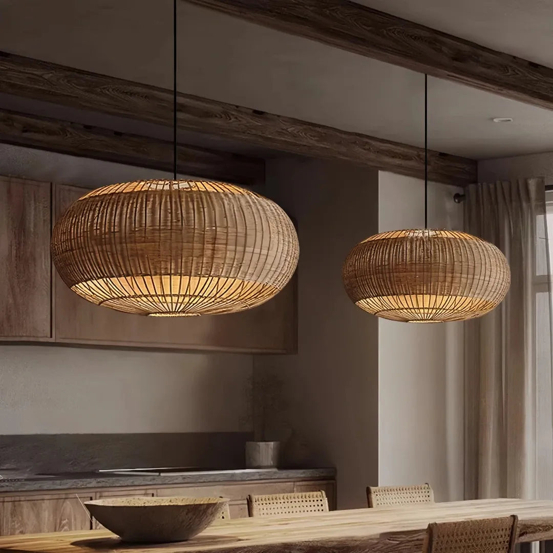Two oval rattan pendant lights above a dining table, shown as a styling example