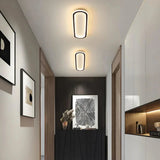 Oval flush ceiling light installed on a modern hallway ceiling现