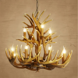 Brown faux antler chandelier lit against a beige wall