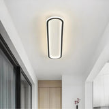 Oval flush ceiling light installed on a modern hallway ceiling现