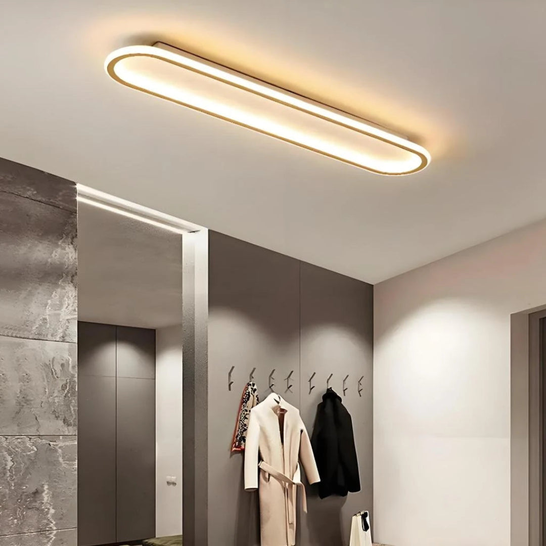 Gold oval flush ceiling light with integrated LED lighting