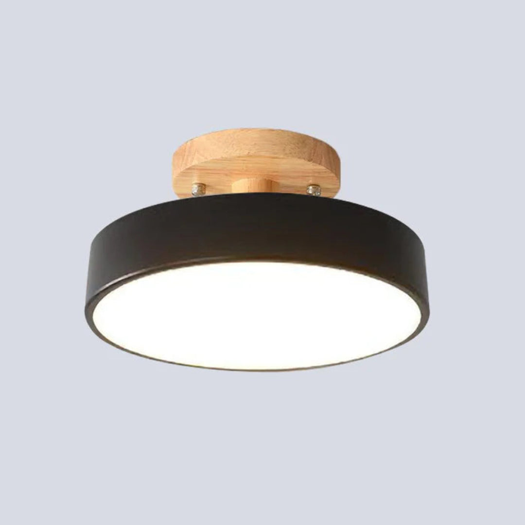 Side view of a round semi-flush ceiling light with acrylic diffuser