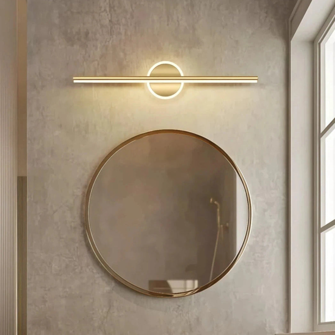 Gold square-detail linear LED bathroom mirror light above a round mirror