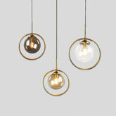 Clear, amber and grey glass pendant lights with gold-tone metal rings