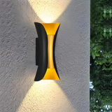 Black and gold finish on a curved outdoor wall light