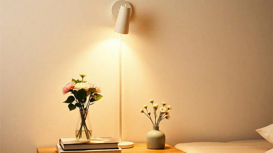 Rechargeable wall light mounted beside a bed for modern reading convenience.