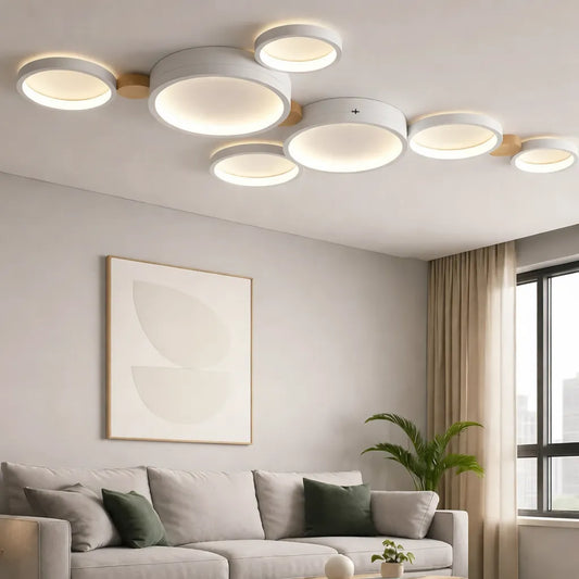 Modern living room with multi-ring LED flush ceiling light, warm glow, minimalist decor and neutral sofa for low ceilings.