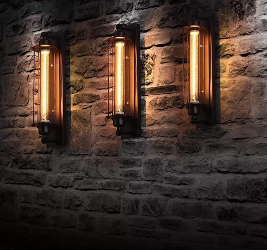 Industrial-style wall lamps with warm amber light mounted on a rustic stone wall, creating a vintage and cozy ambiance.