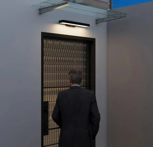 Modern LED wall light above a front door, offering stylish and functional illumination for the entrance, enhancing the home's exterior design.