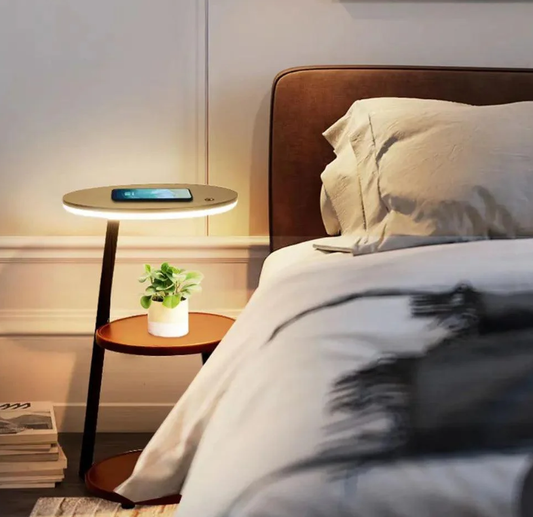 Modern bedside LED lamp with wireless phone charging, warm ambient glow beside the bed—compact nightstand lighting.