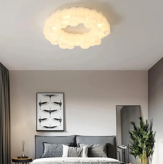 Minimalist geometric ring led ceiling light illuminates a modern bedroom, showcasing soft ambient glow for a cosy and stylish British home interior.