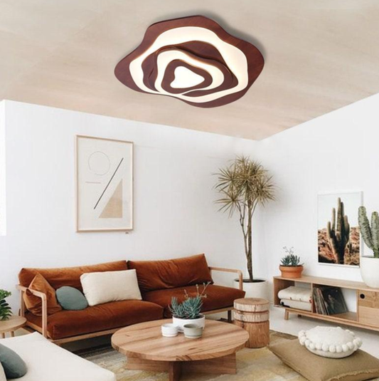 Modern minimalist living room with wooden furniture, round coffee table, sculptural ceiling light, warm sofa, and plants in Nordic interior design.