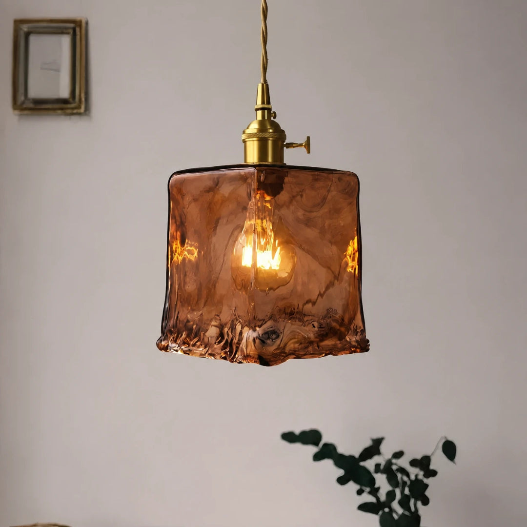 Amber glass pendant light with a rectangular shade and adjustable hanging cord