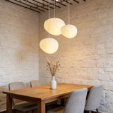 Three-light white pebble pendant arrangement