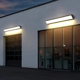 Two black linear wall lights above large glazed openings