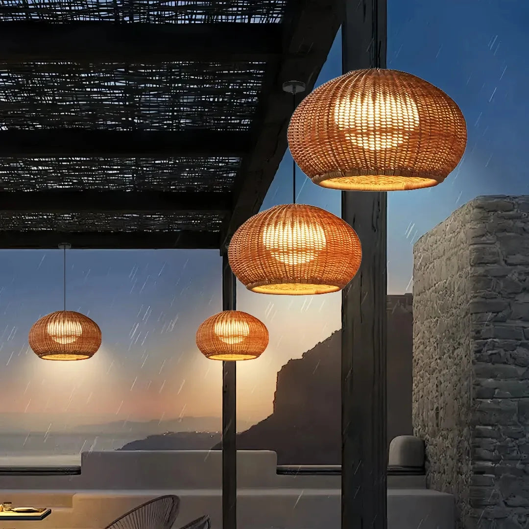 Side view of a round rattan outdoor pendant light  