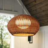Woven rattan lantern shade of an outdoor pendant light 