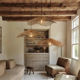 Three-light wave rattan pendant in a living room with a timber-beam ceiling