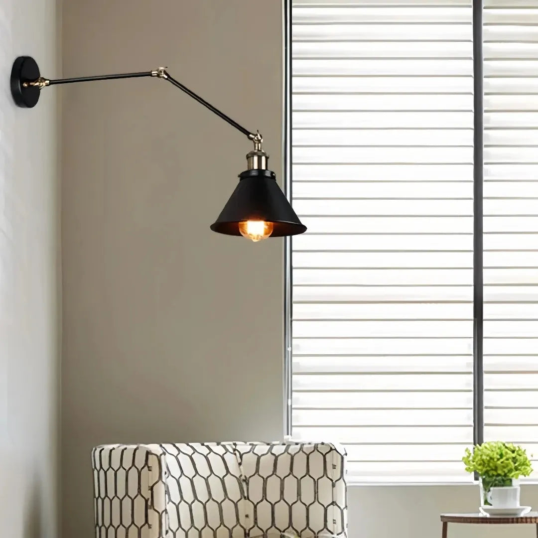 Industrial wall light mounted beside a bed for reading