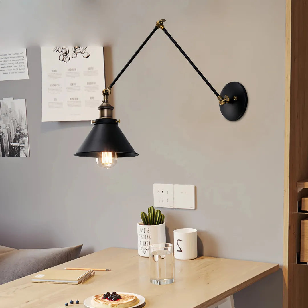 Foldable arm indoor wall light adjusted towards a bedside table