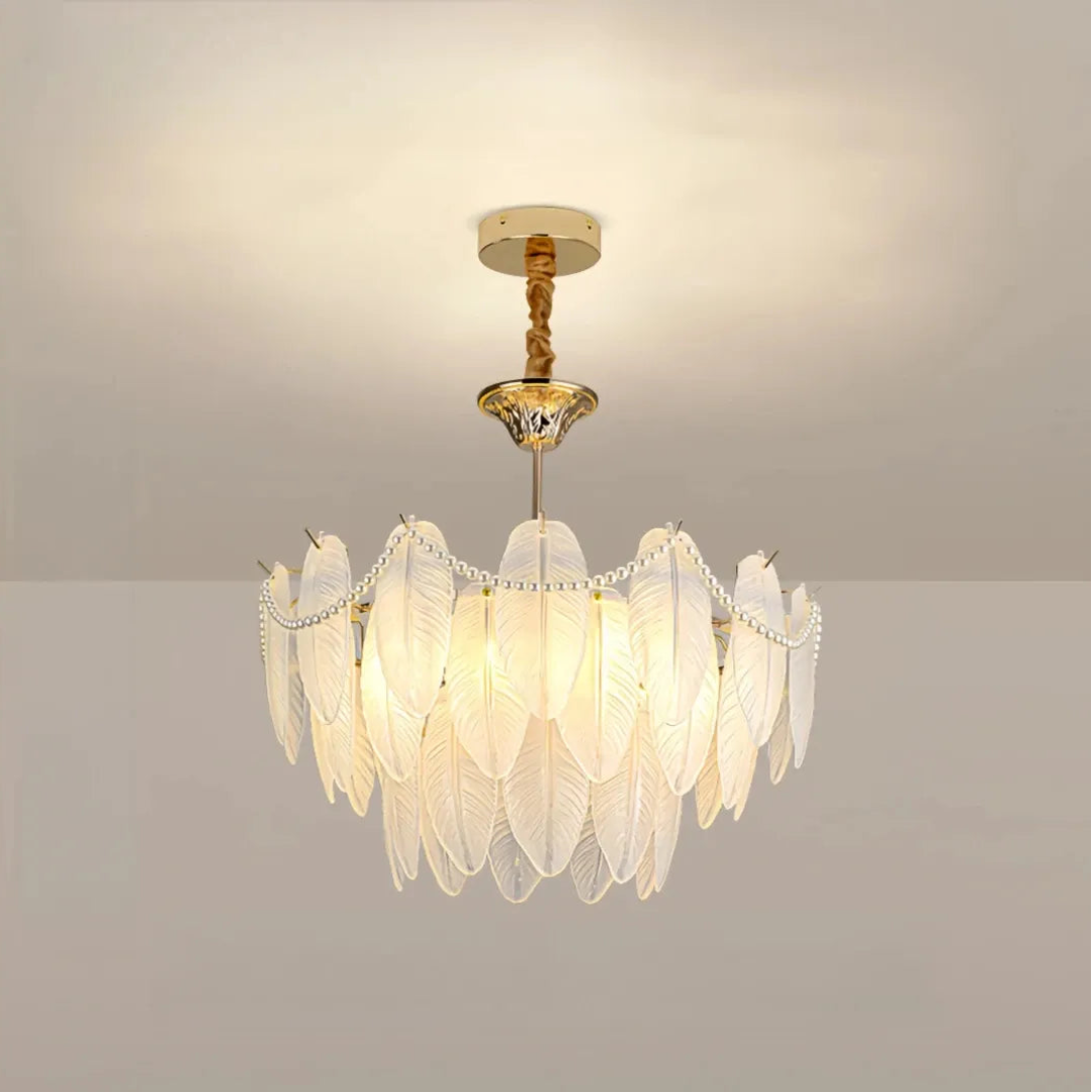 Front view of the illuminated chandelier with layered glass feathers and bead swags