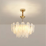 Front view of the illuminated chandelier with layered glass feathers and bead swags