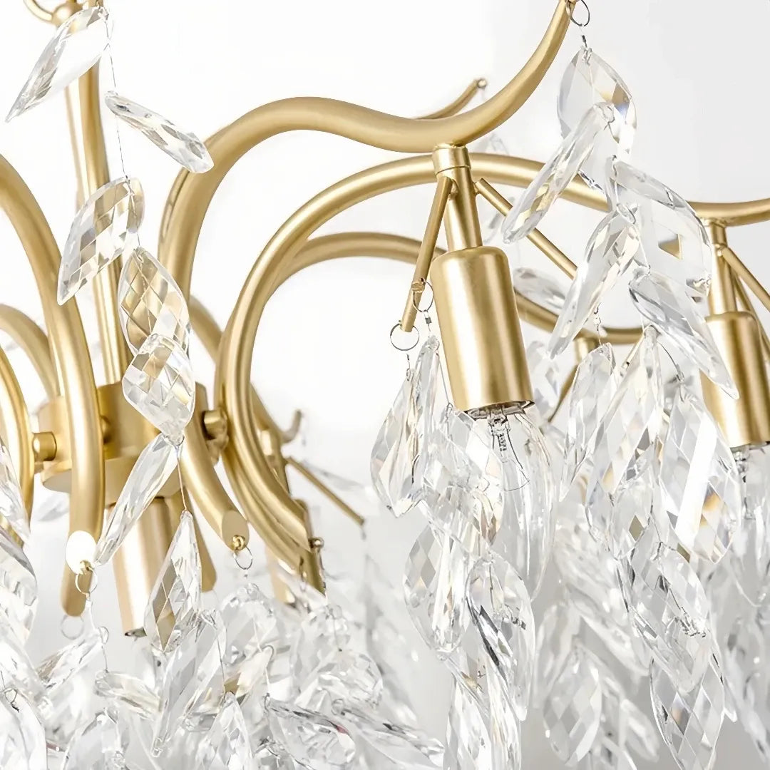 Close-up of textured crystal leaves on a gold chandelier