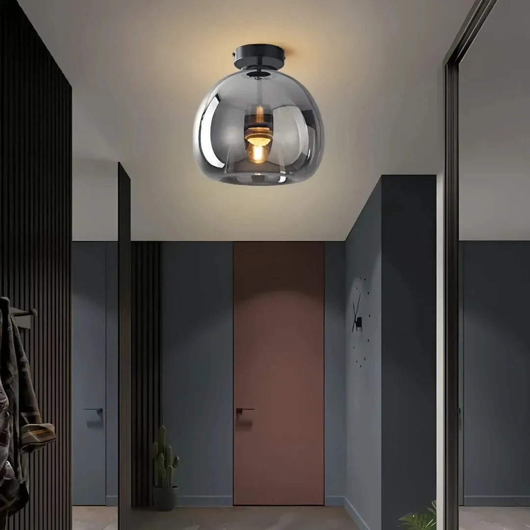 Black glass flush ceiling light in a mid-century style