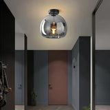 Black glass flush ceiling light in a mid-century style