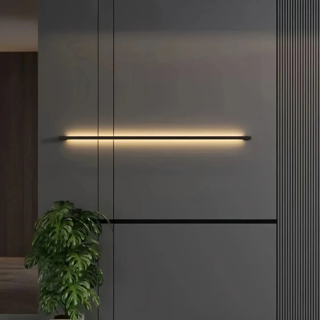 Dimmable black linear wall light mounted on a dark feature wall
