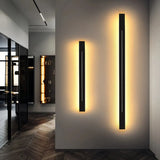 Black linear wall light shown in a modern room setting