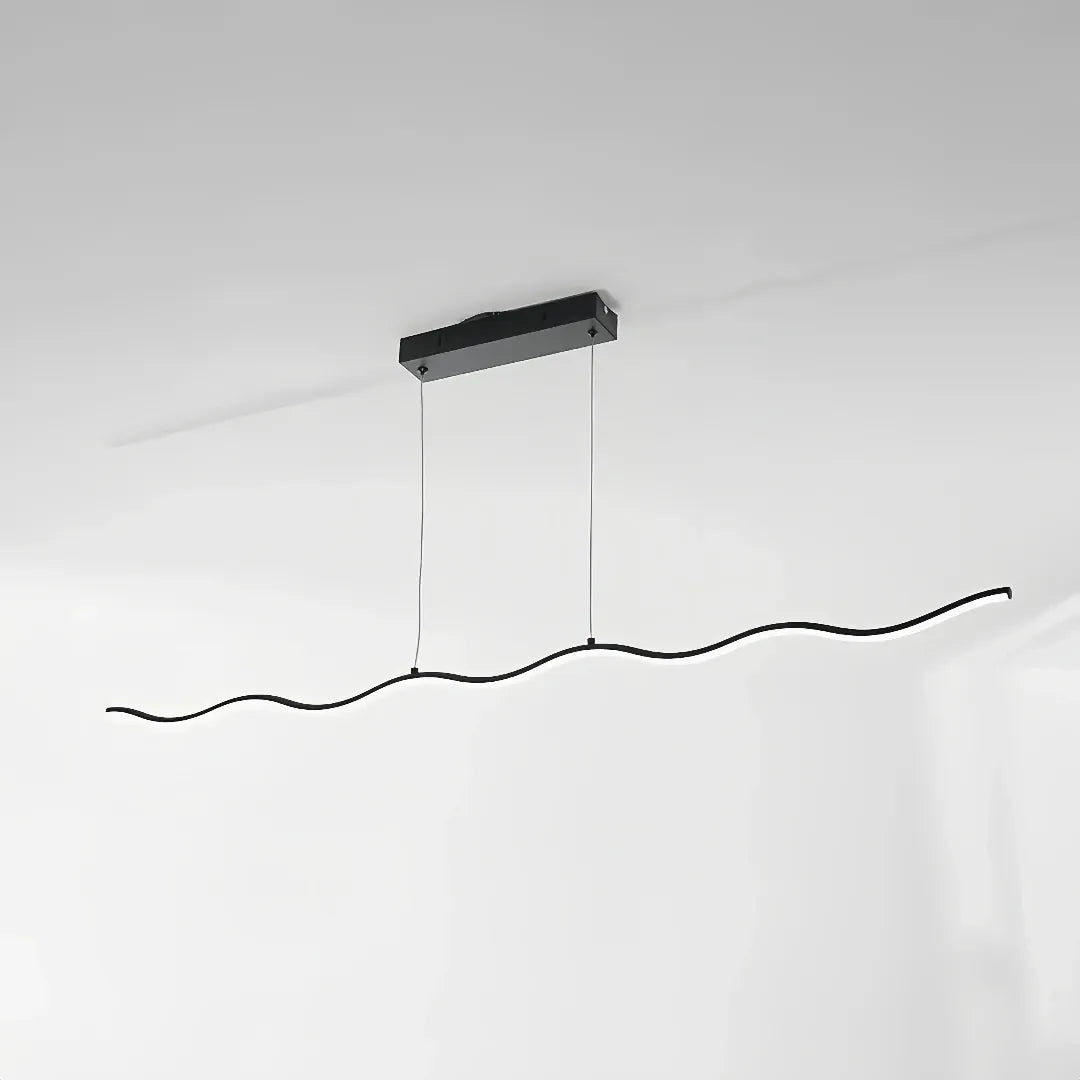 Black wave LED pendant light above a marble-effect dining table