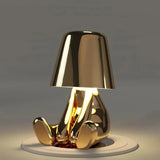 Gold touch bedside table lamp on a bedroom side table