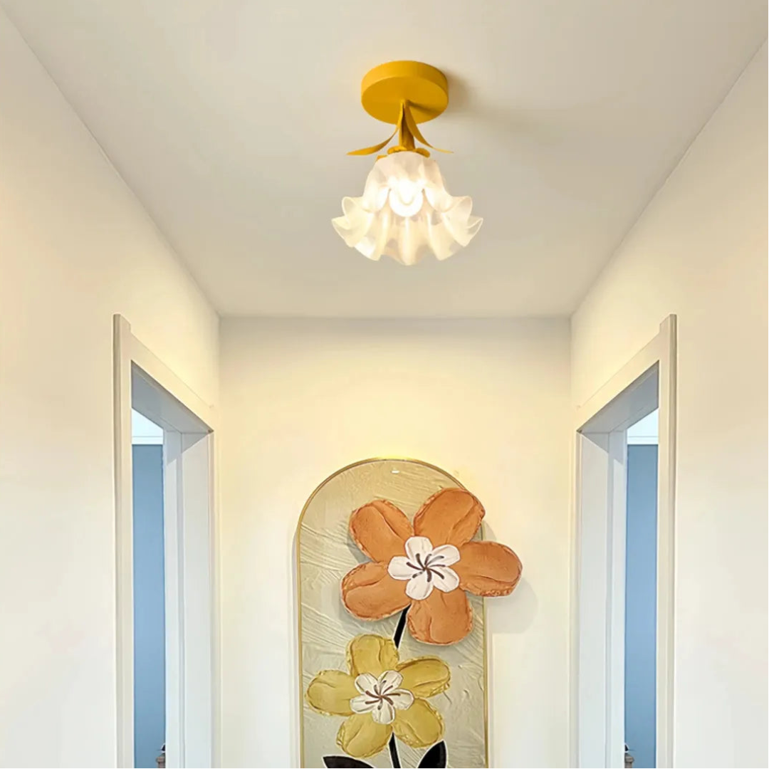 Yellow flower-shaped glass shade on a ceiling light 