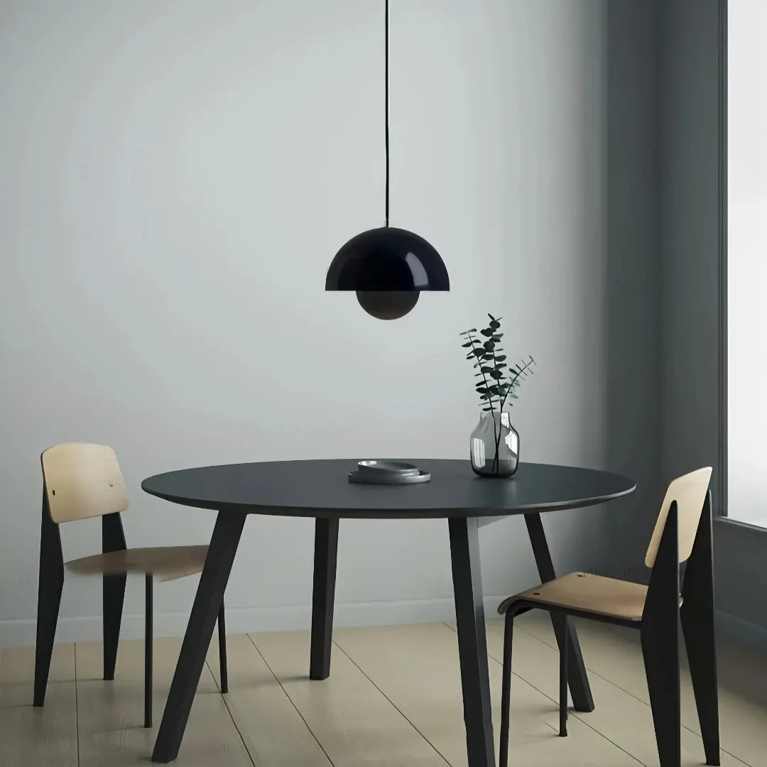 Black double-shade pendant light in an interior with dark wood furniture