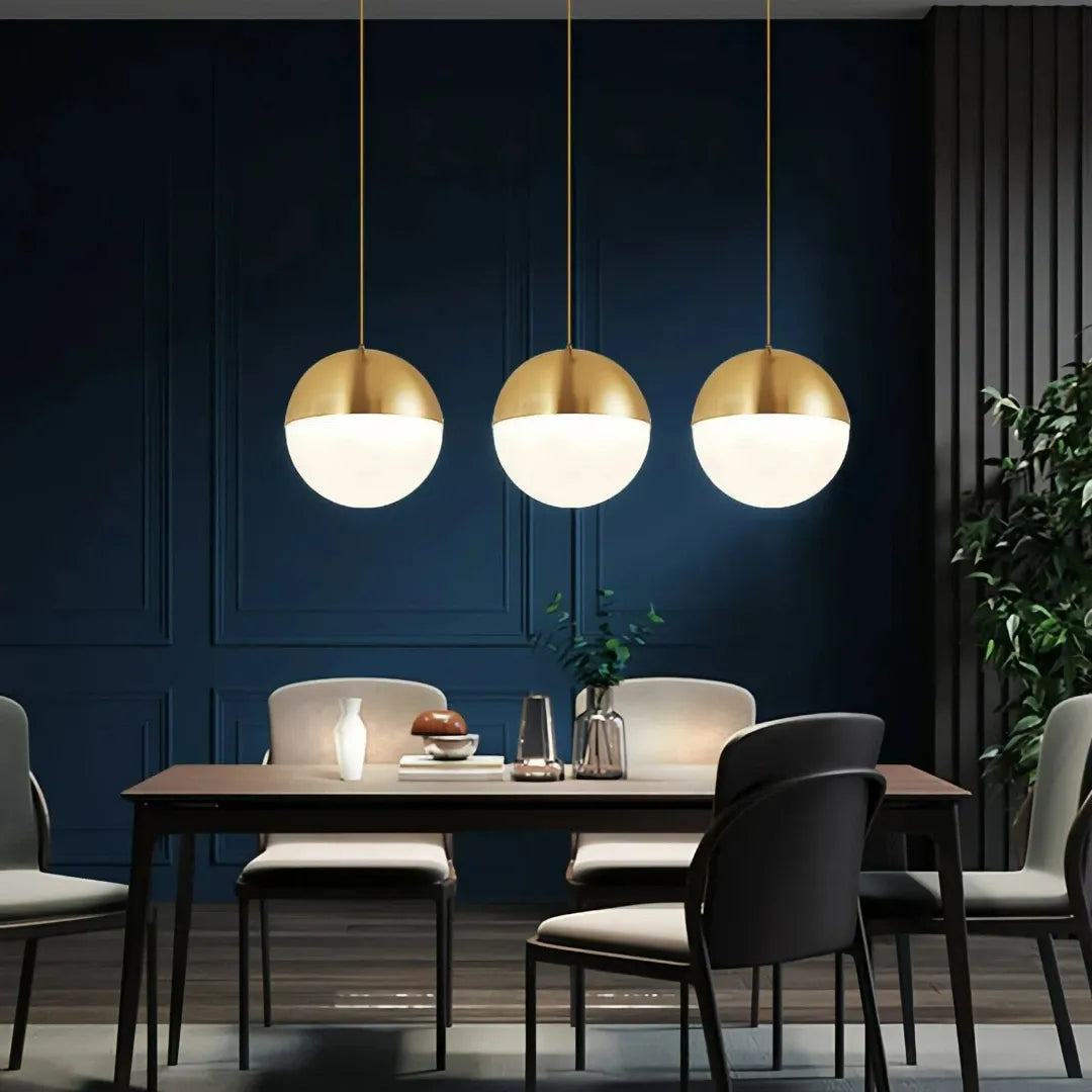 Glass globe pendant lights hanging above a kitchen island
