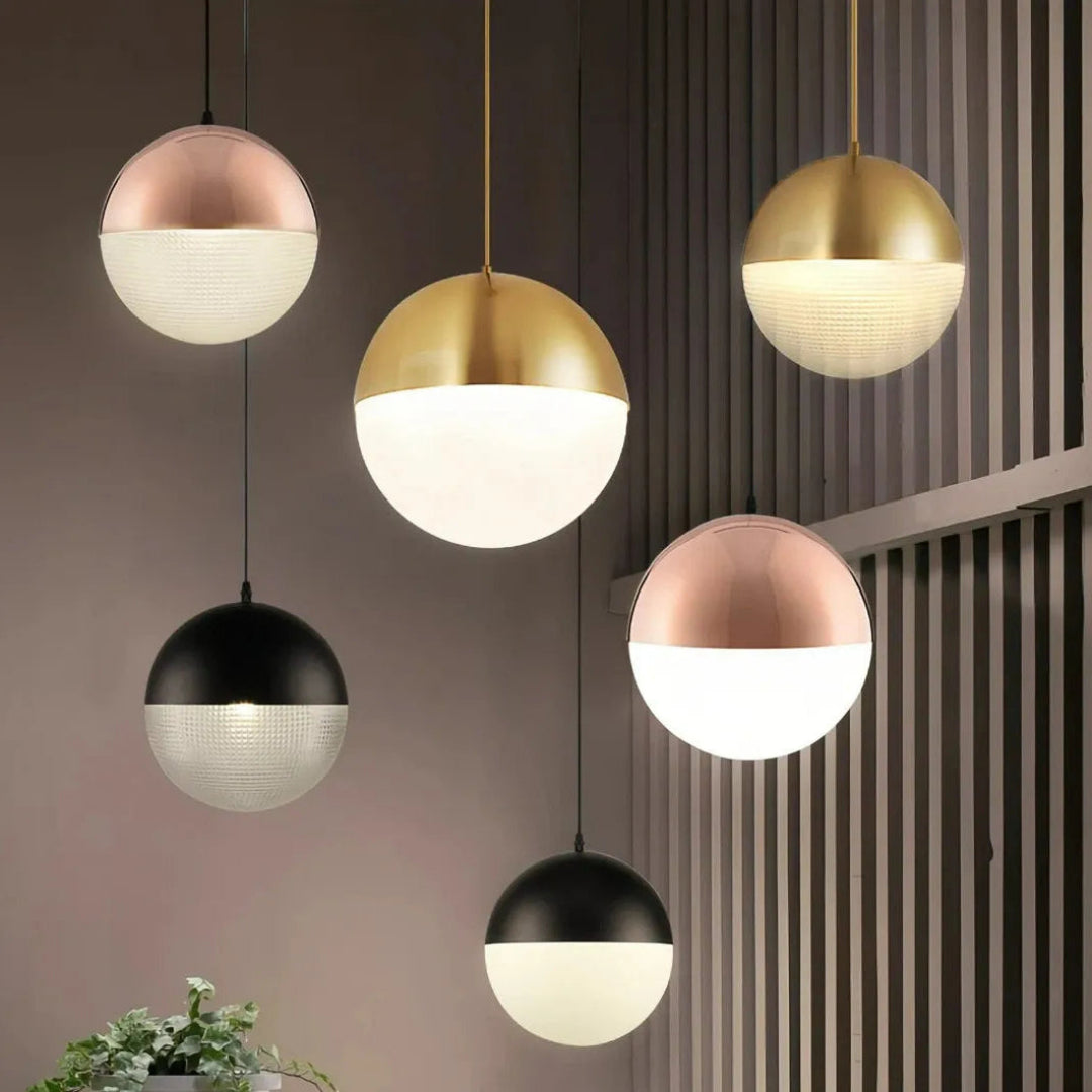 Cluster of glass globe pendant lights above a dining table