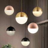 Cluster of glass globe pendant lights above a dining table