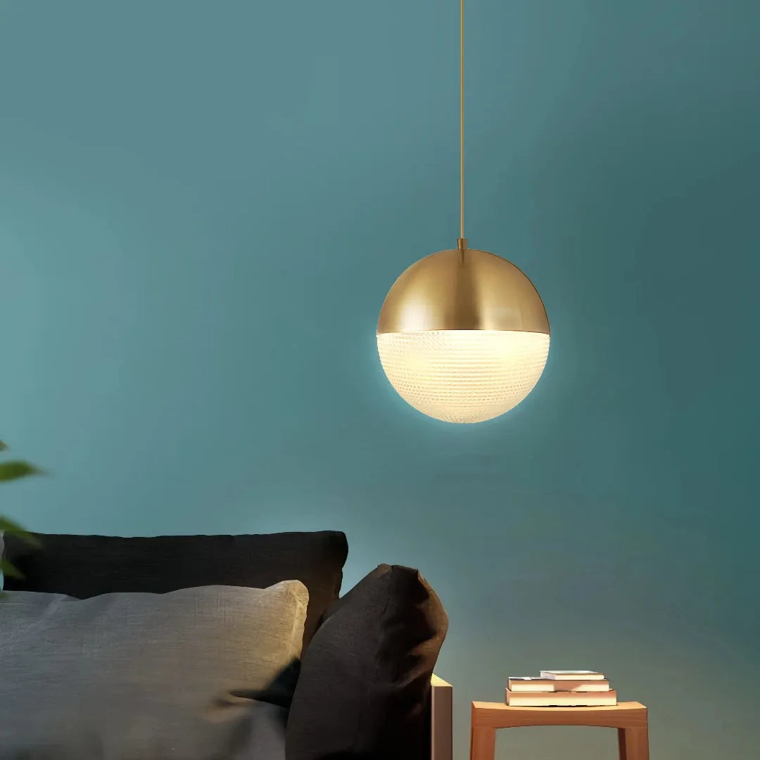 Gold pendant light with clear grid-patterned glass globe