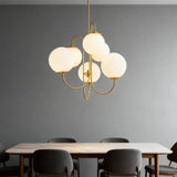 Six-light glass globe chandelier above a dining table