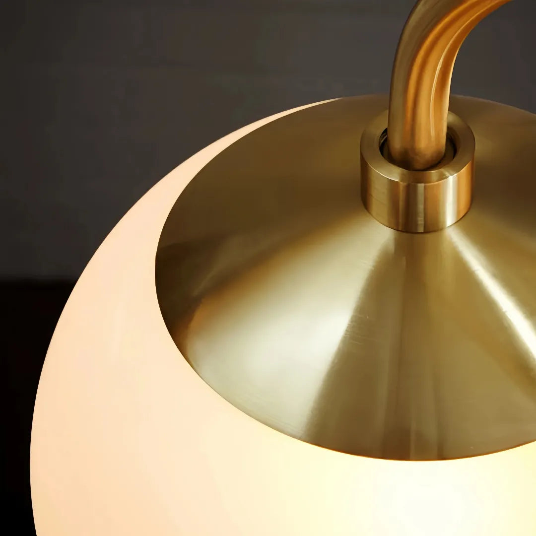 Close-up of the metal cap on an illuminated opal glass globe