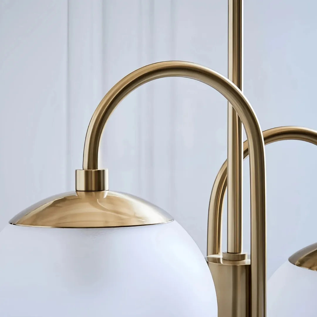Close-up of a curved metal arm and an unlit glass globe