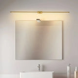 Gold linear LED wall light mounted above a bathroom mirror