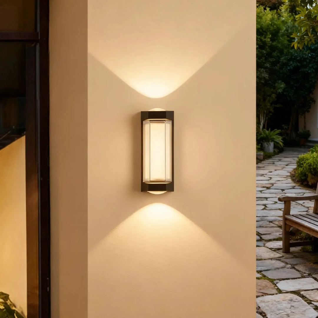 Black up and down wall light with warm lighting on a patio wall