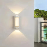 White outdoor wall lights shown on exterior walls in daylight and at dusk