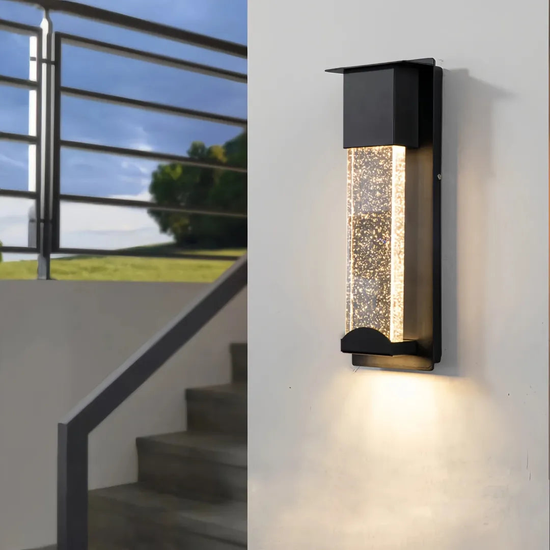 Illuminated black wall light with a rectangular frame and bubble-textured crystal glass panel