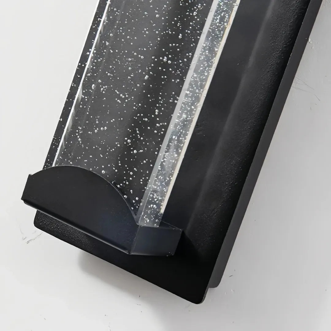 Close-up of the black metal housing and clear crystal glass panel