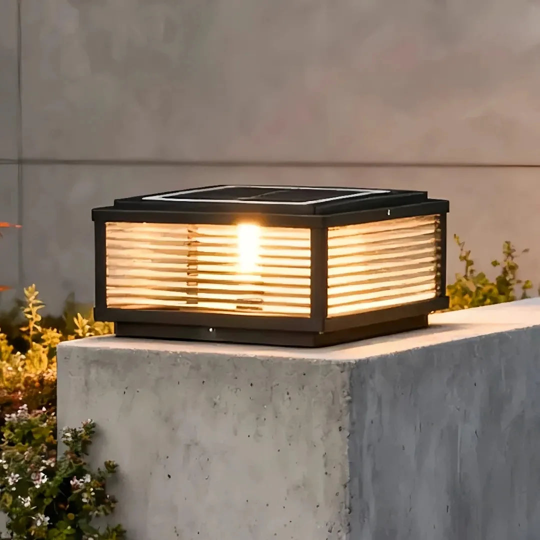 Solar outdoor pillar light glowing warm white at night